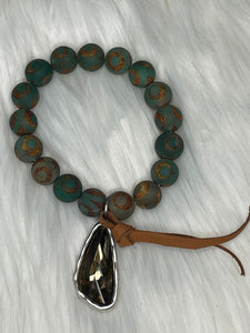 Sandra Ling- Green Stones with a polished goldish gem bracelet